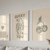 Three framed canvas prints featuring the text LUCKY YOU and a stylized silhouette of a bird and apples.
