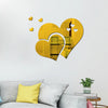 Gold heart wall art decal featuring a large heart shape with smaller hearts and yellow floral accents on a white wall.