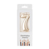 A gold number candle shaped like the number seven for birthday party decor.