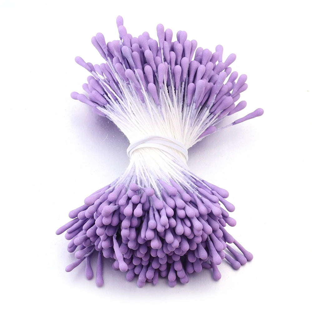A cluster of purple artificial flower stamens with white filaments and a base for DIY decoration.