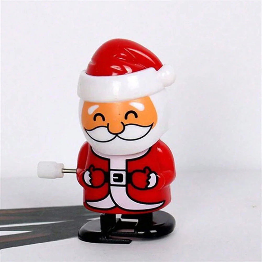 A small red and white figurine of Santa Claus with a white beard and mustache.