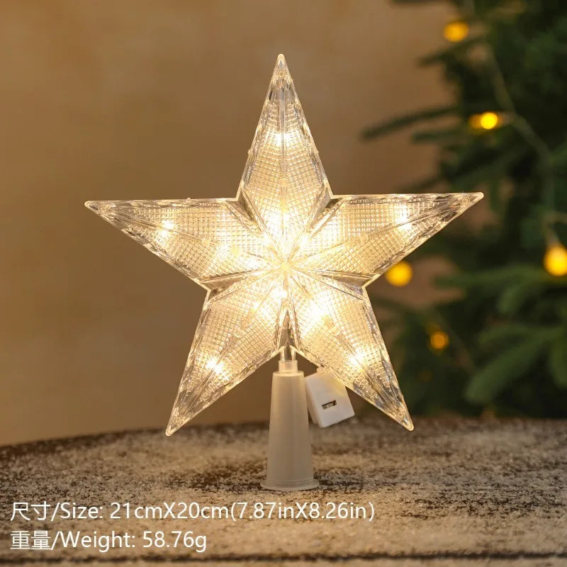 A sparkling LED Christmas tree star topper with a warm white glow displayed on a surface.