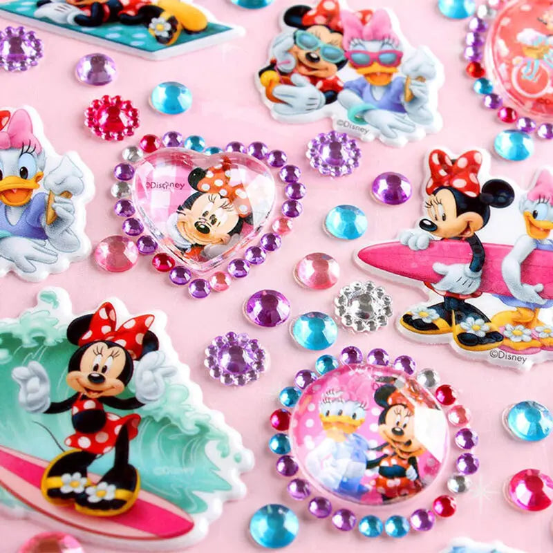 A collection of colorful self-adhesive rhinestone embellishments and Disney-themed stickers on a pink background.