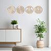 A set of four circular, concentric wooden wall art pieces with natural light wood tones mounted on a white wall.