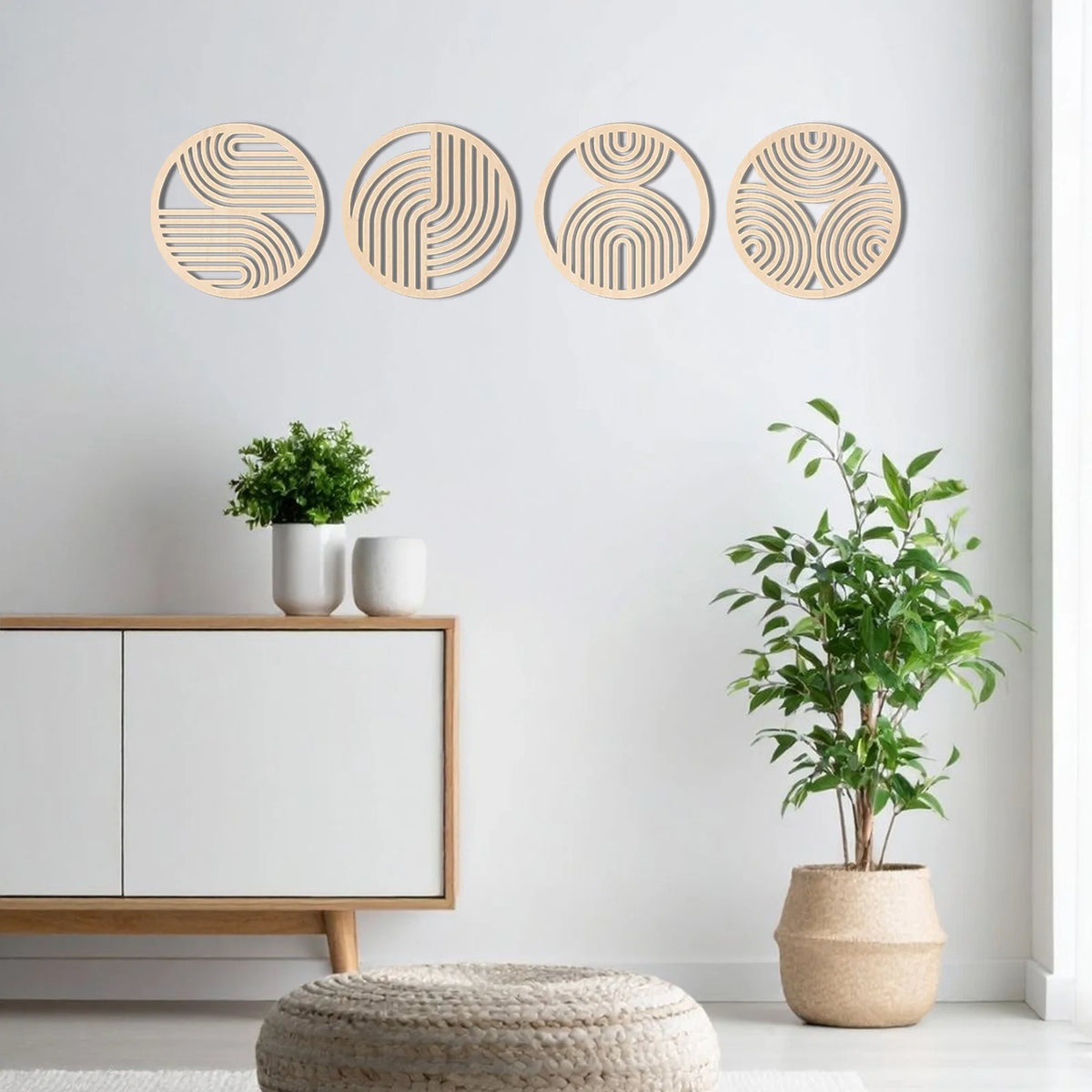 A set of four circular, concentric wooden wall art pieces with natural light wood tones mounted on a white wall.