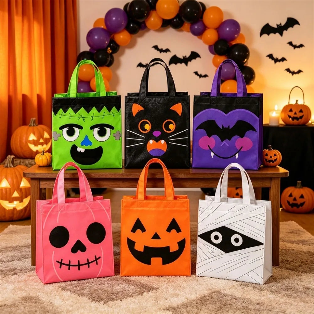 A set of two reusable Halloween candy bags in pink and orange, displayed in front of a decorated wall with bat and pumpkin de