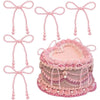 A set of pink pearl bow cake toppers and decorations for elegant party use
