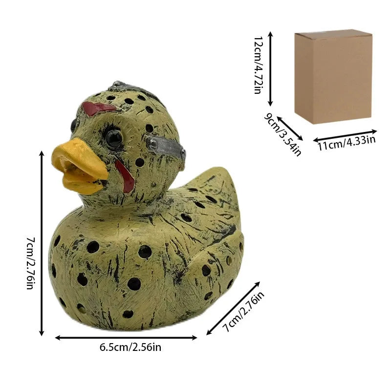 A small, speckled resin figurine of a duck with a painted face, packaged in a cardboard box.
