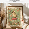 A framed canvas print featuring a woodland mouse sitting on a red and white mushroom surrounded by green foliage.