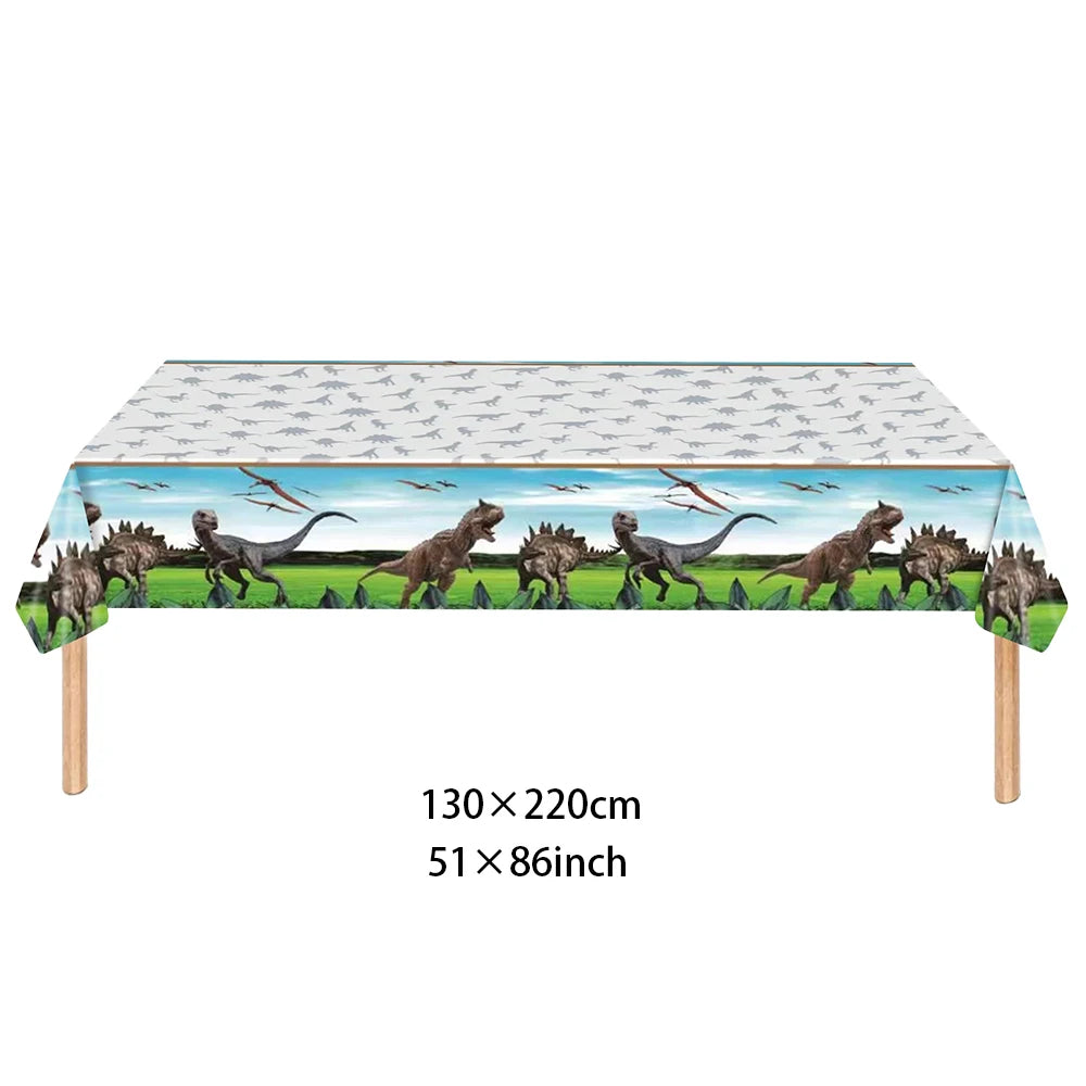 A banner featuring dinosaurs across the top of a rectangular table cloth or backdrop.
