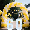 A large archway made of yellow and white balloons framing a light-up marquee number sign displaying 60.