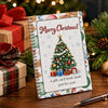 A gift card book with a Christmas theme featuring a decorated green tree and snowflakes