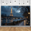 A photograph of the Eiffel Tower at dusk over a city skyline with a large moon visible in the sky.