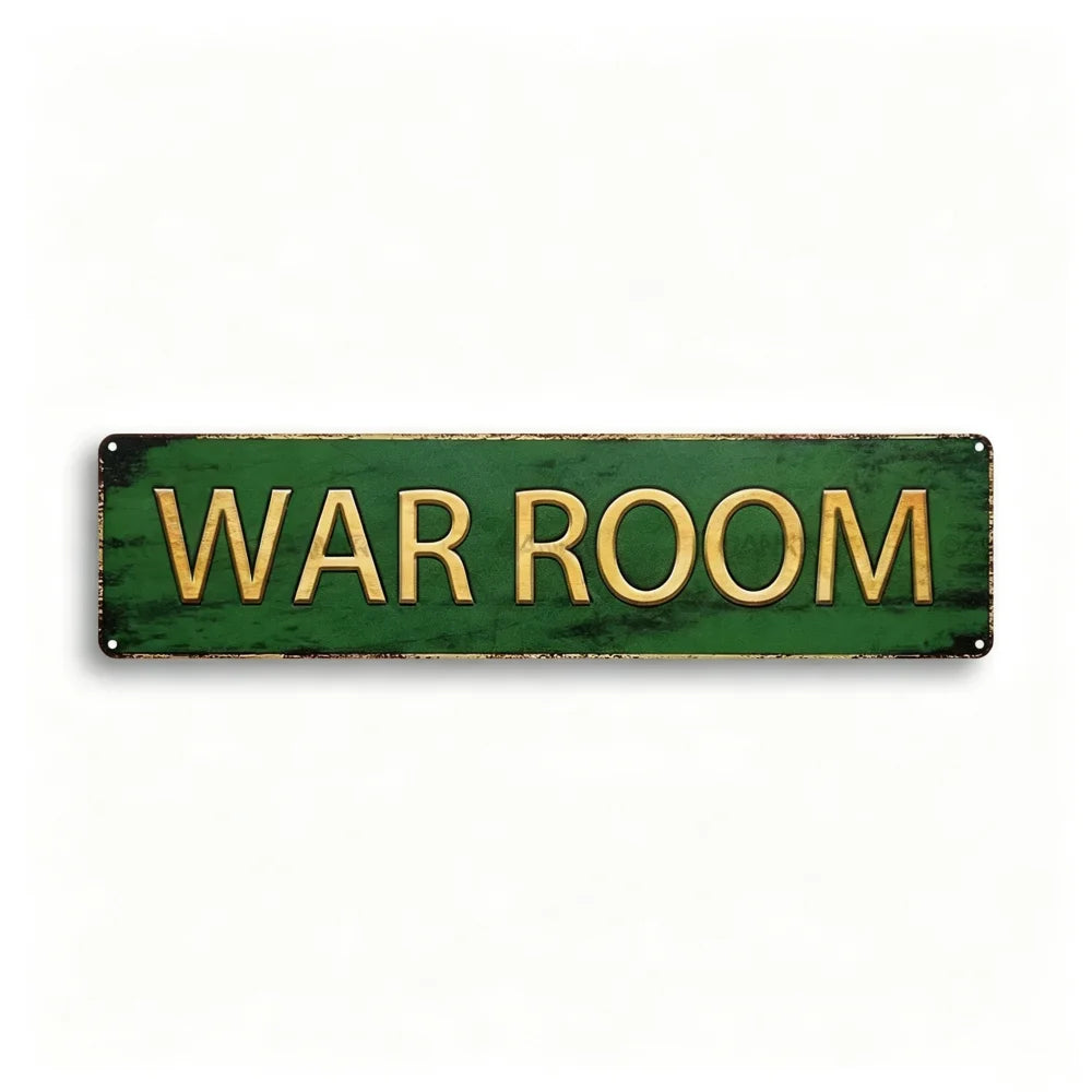 A rectangular, distressed green metal tin sign with the words WAR ROOM written in gold lettering.