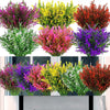 A collection of artificial lavender stems in various shades of purple, pink, yellow, and red displayed in a planter.