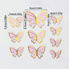 A set of five pink butterfly cake toppers with gold accents, measuring approximately 5.3 cm wide.