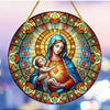 A translucent acrylic Mary suncatcher featuring the Virgin Mary and the Christ Child surrounded by a radiant golden halo.