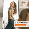 A woman is reflected in an HD reflection on a floor mirror, showing her full body and clothing.