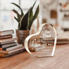 A clear acrylic heart plaque engraved with 'Dear Dad I love you' and inspirational text, resting on a wooden surface.