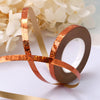 Roll of copper-colored satin ribbon for crafting or decoration