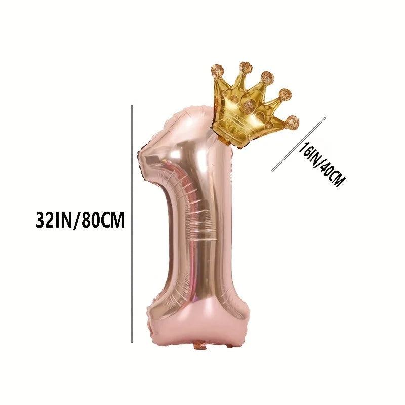 A rose gold foil balloon shaped like the number one with a gold crown topper.