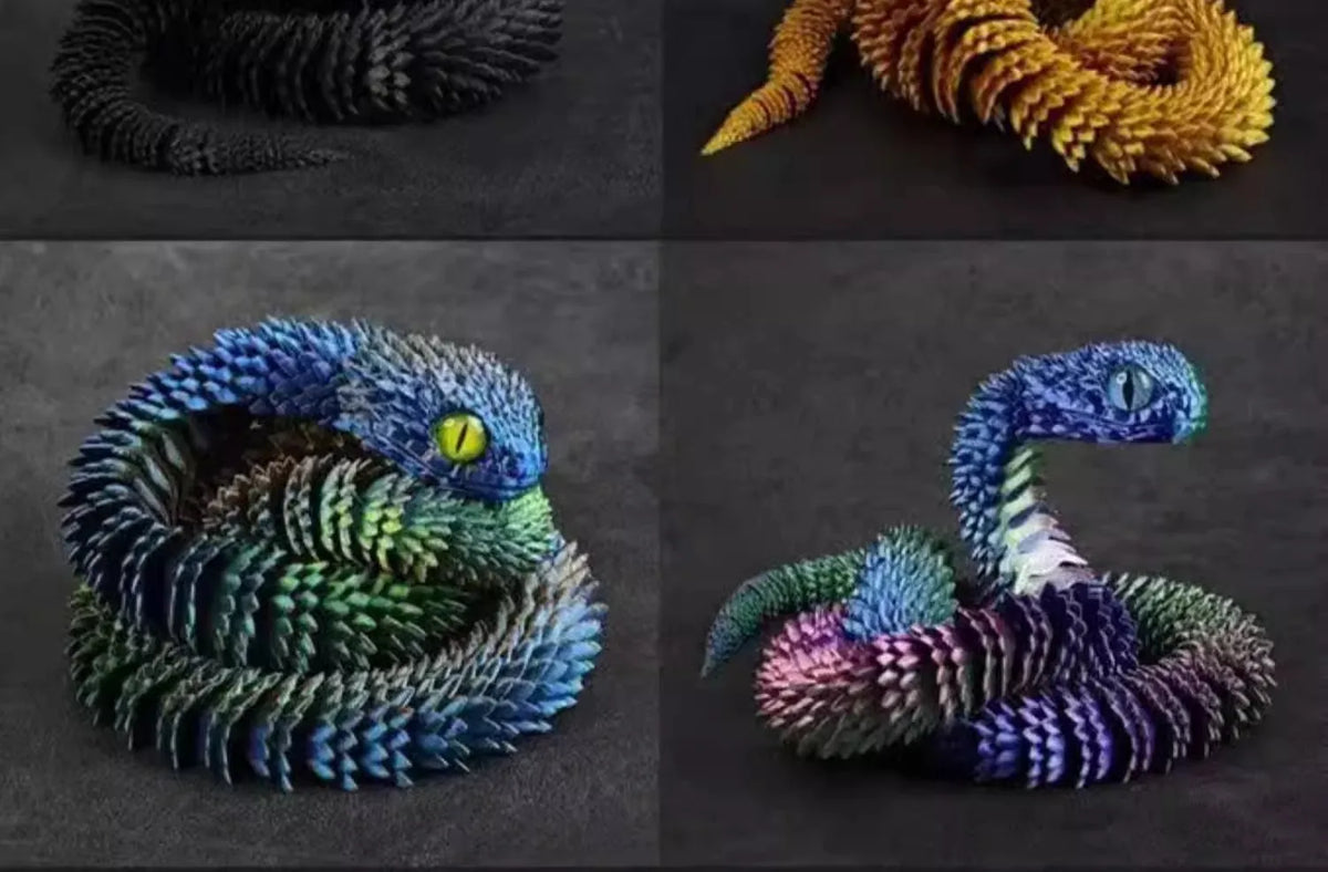 A set of three 3D printed rotatable snake art models in black, yellow, and blue colors.