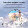 A clear holographic crystal ball video player with a string attached, showcasing various media and memory specifications.