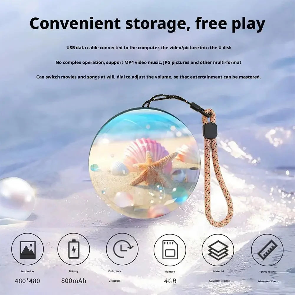 A clear holographic crystal ball video player with a string attached, showcasing various media and memory specifications.
