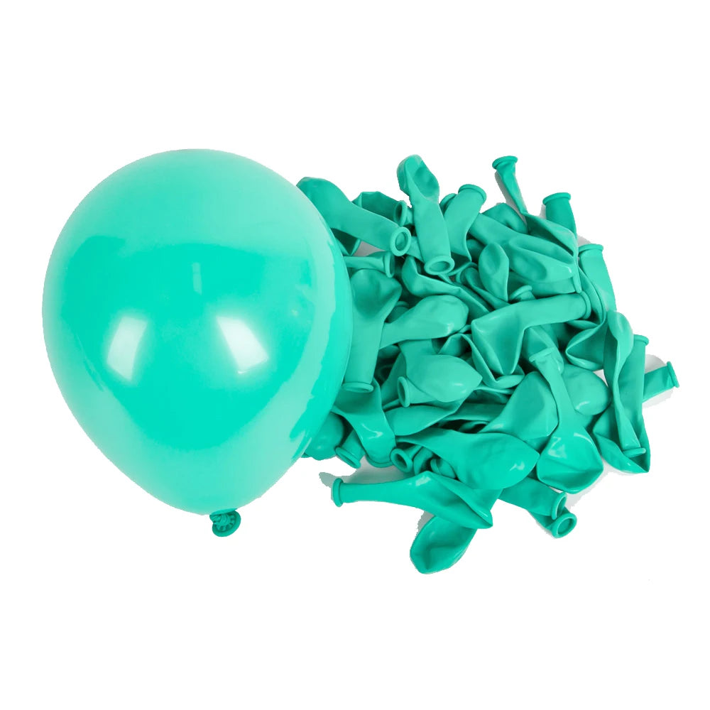 A light turquoise latex balloon next to a bunch of teal colored latex balloons.