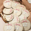 A collection of wooden baby milestone cards showing numbers 1 through 12 for monthly photo props