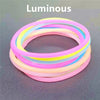 A set of ten luminous silicone bracelets in various pastel colors, including pink, yellow, and blue.