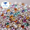 A close-up of a scatter of colorful acrylic diamond gemstones in various shades and sizes.