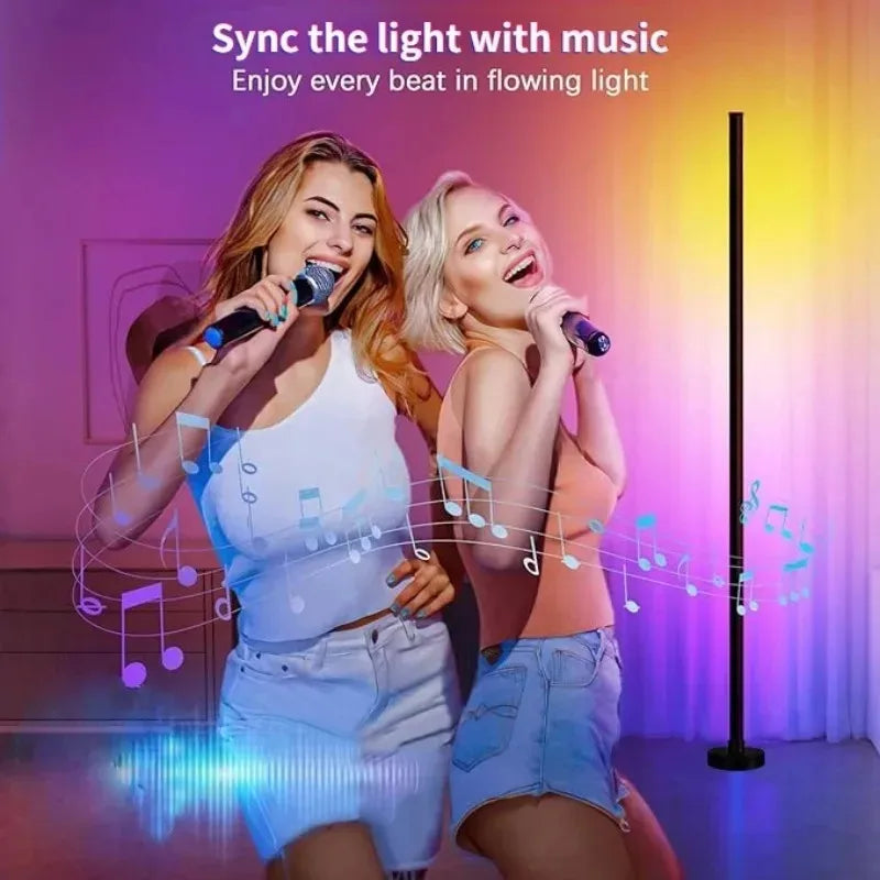Two women singing into microphones with light flowing in sync to the music from an RGB floor lamp