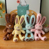 A collection of five giant kawaii rabbit plush toys in various pastel colors and textures displayed against a light backgroun