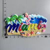 Colorful fridge magnets featuring the word Miami and a woman in a tropical setting