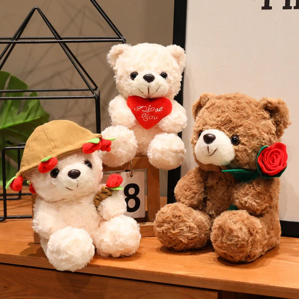 Two teddy bear plush toys, one white with a red heart and another brown with a red rose, displayed on a wooden surface.