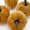 A set of five small, textured orange foam pumpkins used for Halloween decoration.