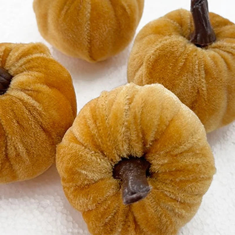 A set of five small, textured orange foam pumpkins used for Halloween decoration.
