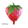 A vibrant red strawberry shaped foil balloon with green leaves.