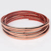 Copper-colored self-adhesive PVC wall trim tape rolled into a circular coil.