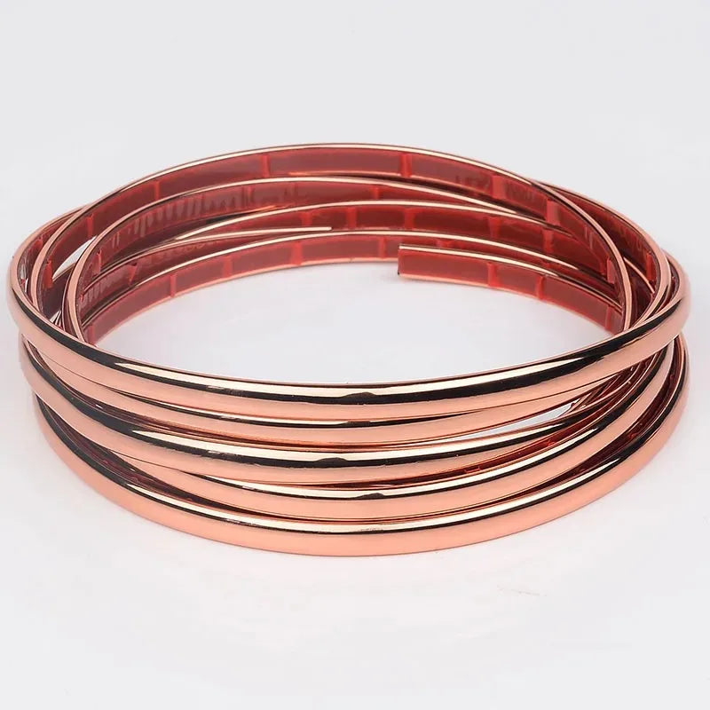 Copper-colored self-adhesive PVC wall trim tape rolled into a circular coil.