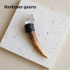 A natural crystal Herkimer scepter wand featuring a clear quartz point and a dark wooden handle.