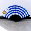 Handheld folding fan featuring a striped design with a sun emblem and blue and white colors.