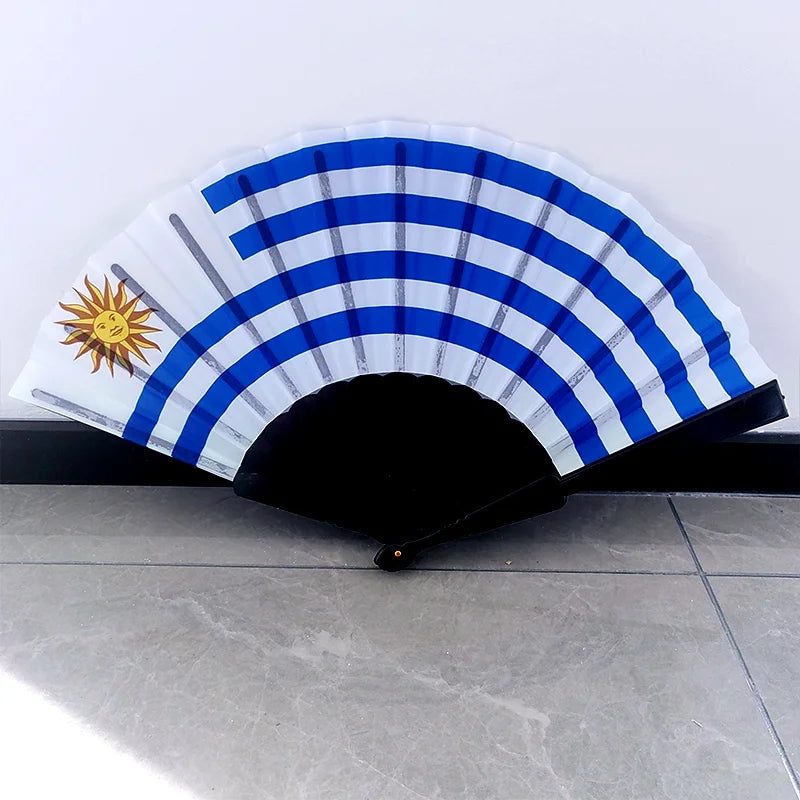Handheld folding fan featuring a striped design with a sun emblem and blue and white colors.