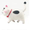 A white and black 3D cartoon cat figure with a red collar standing on a white background.