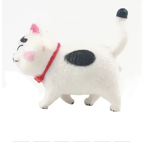 A white and black 3D cartoon cat figure with a red collar standing on a white background.