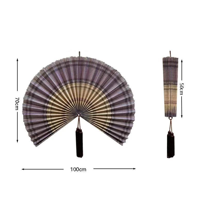 Handwoven bamboo wall fan decor with a pleated fan and tassel