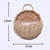 A woven natural fiber wall hanging basket with a round shape and a handle.