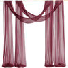 A set of two sheer mauve chiffon fabric panels draped for a wedding arch backdrop.