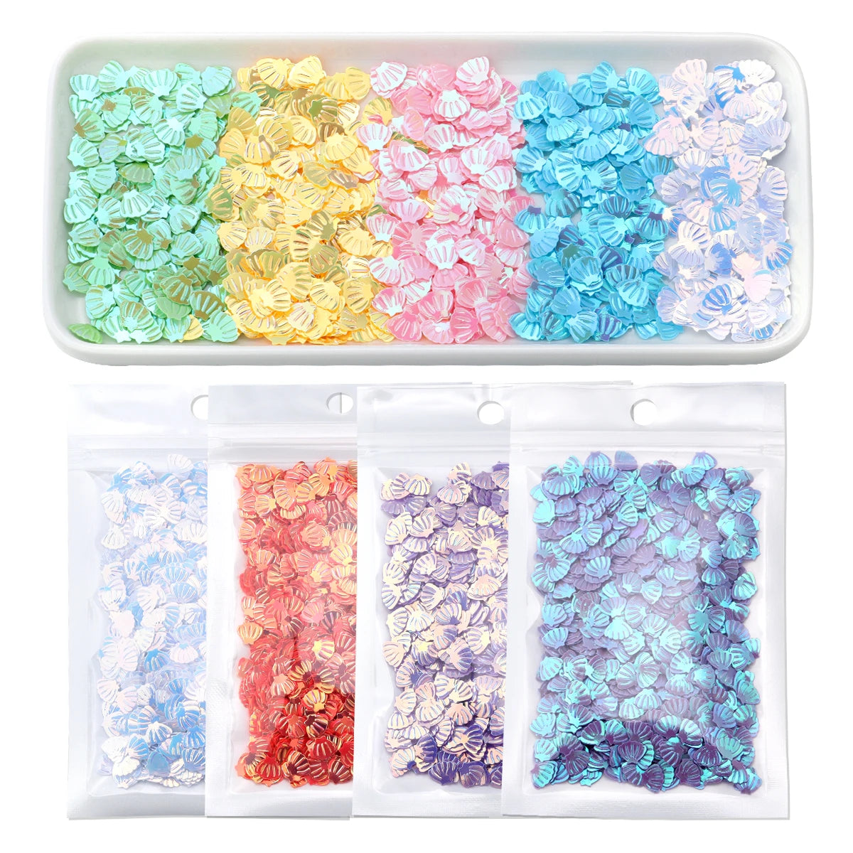 A tray of colorful sea shell PVC sequins in various shades arranged by color.